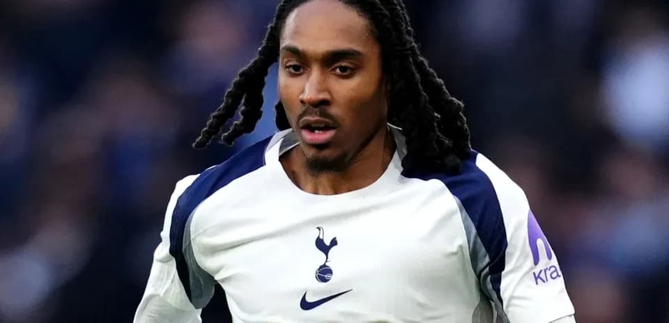Player in Tottenham jersey running on the field