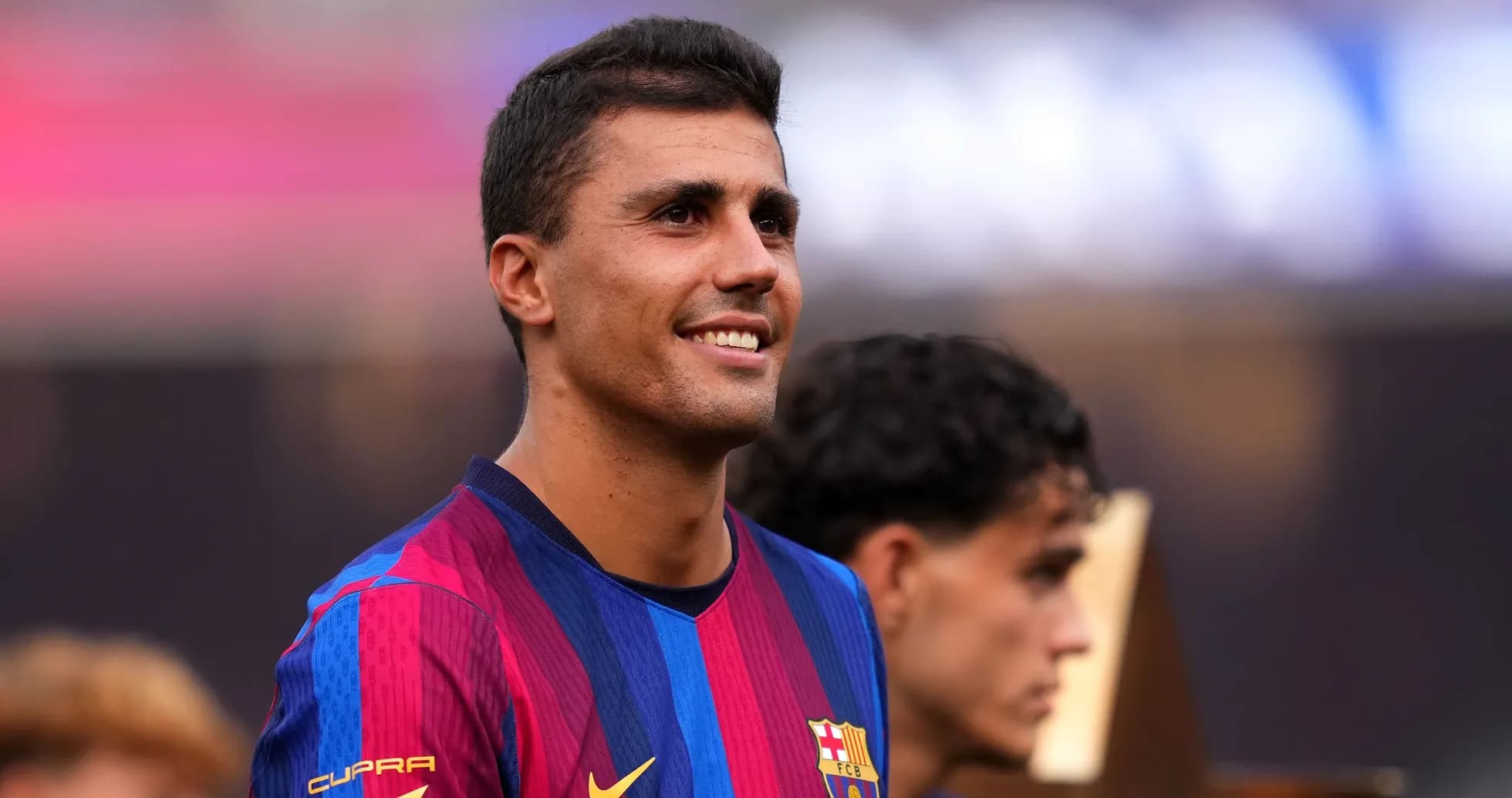 Player smiling while wearing FC Barcelona jersey