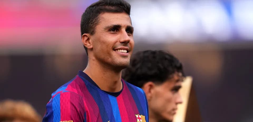 Player smiling while wearing FC Barcelona jersey