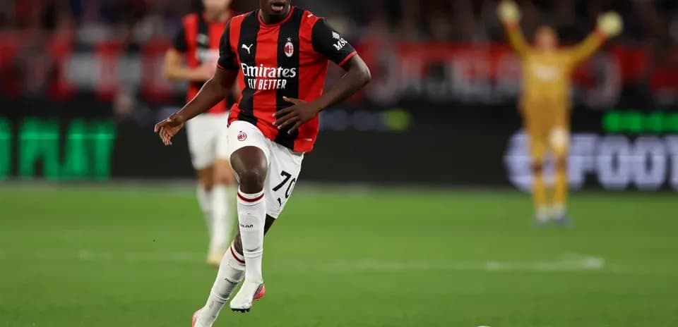 AC Milan player dribbling ball during match