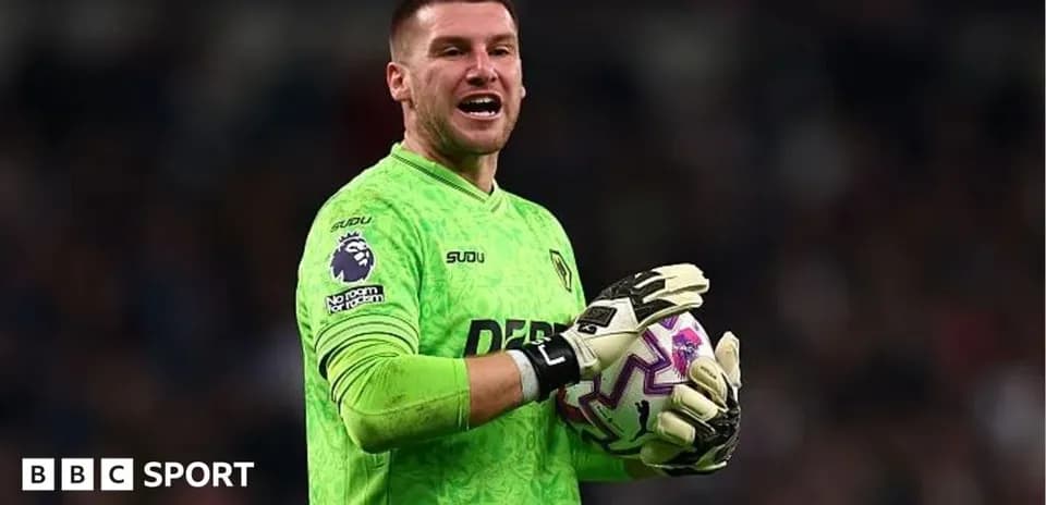Goalkeeper in green kit holding a soccer ball