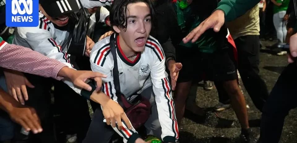 Fans celebrating with a green drink in crowd