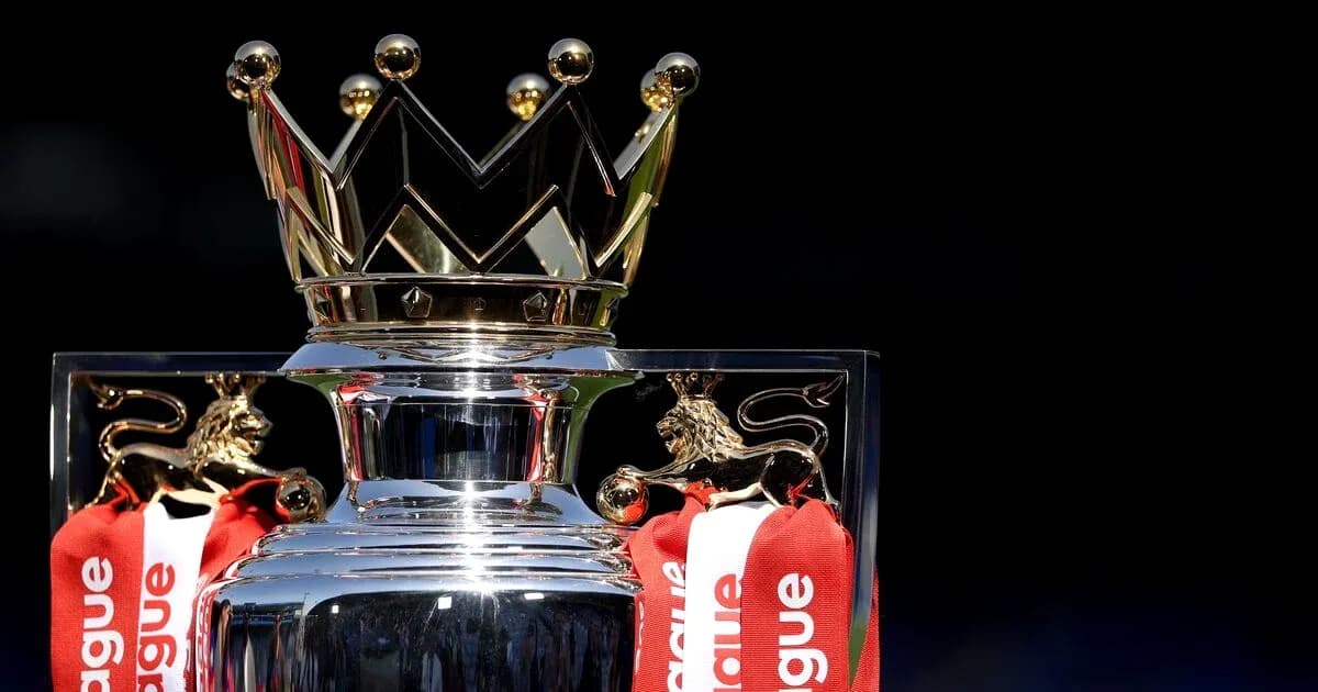 Premier League trophy with red ribbons on display