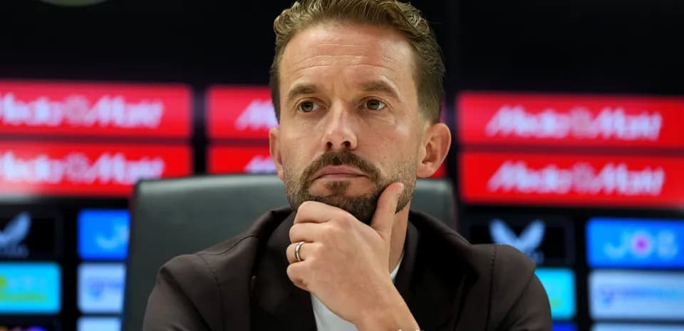 Manager during press conference with thoughtful expression
