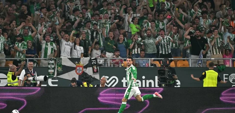 Player celebrating a goal in front of fans
