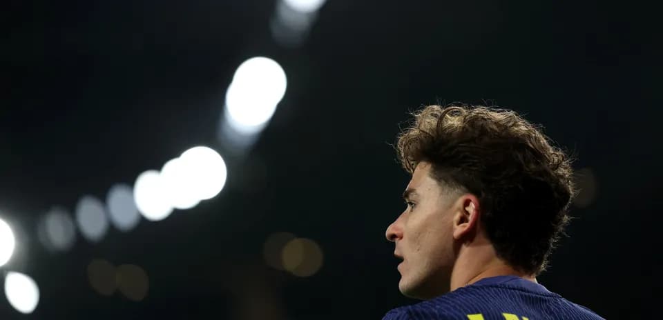 Player with curly hair in stadium lights