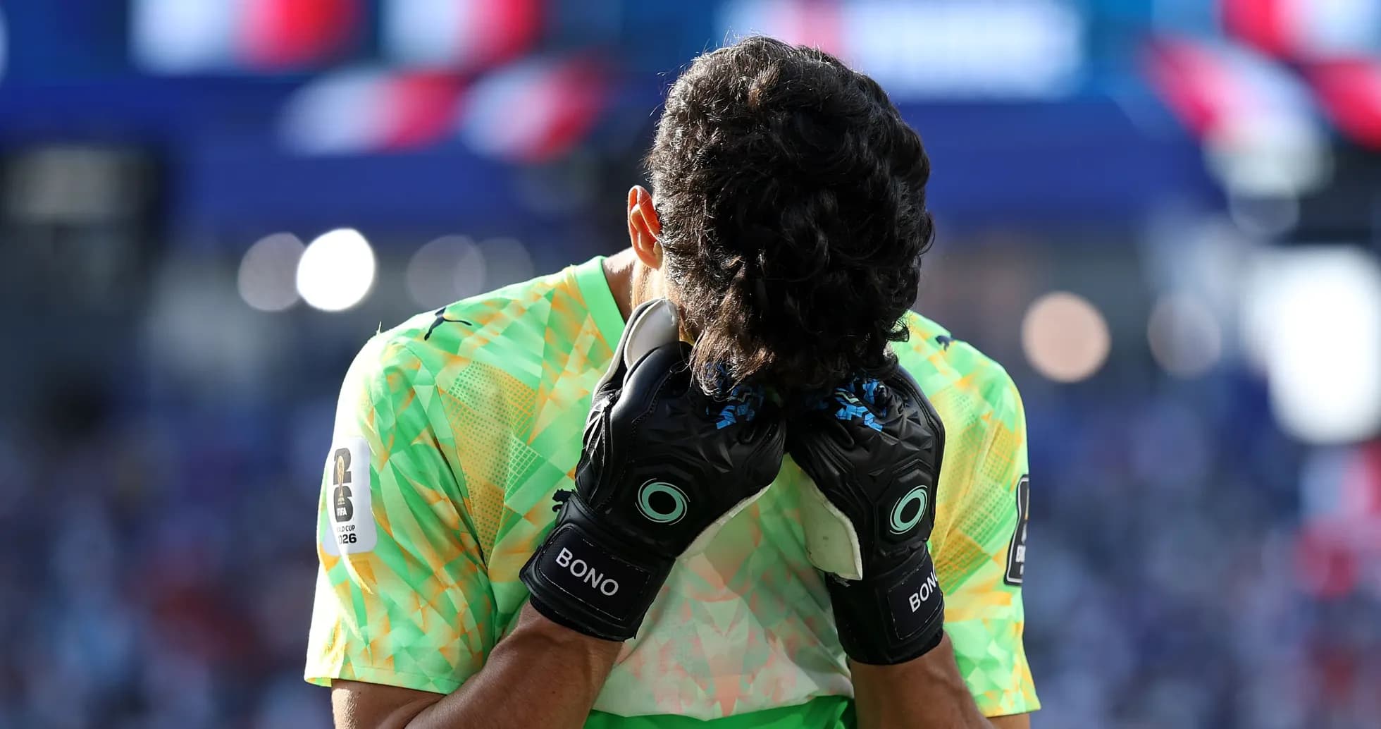 Goalkeeper holding head in distress during match