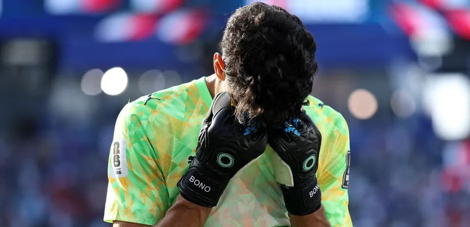 Goalkeeper holding head in distress during match