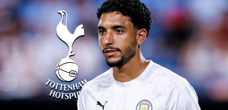 Player in Manchester City kit with logos