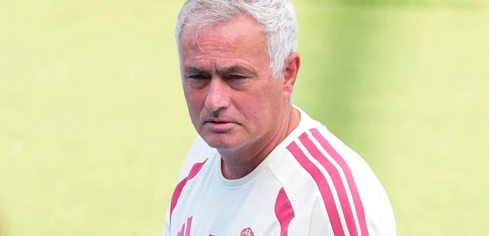 Coach wearing Real Madrid training kit outdoors