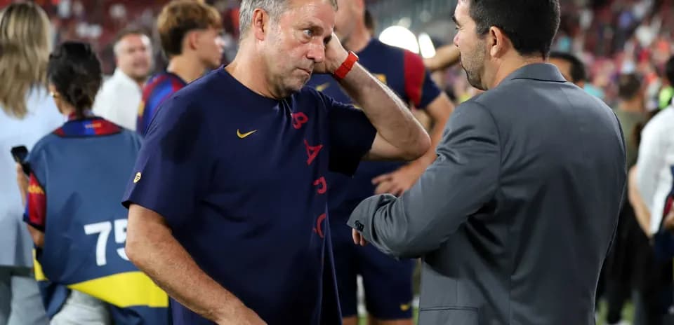 Coaches discussing on the pitch after match