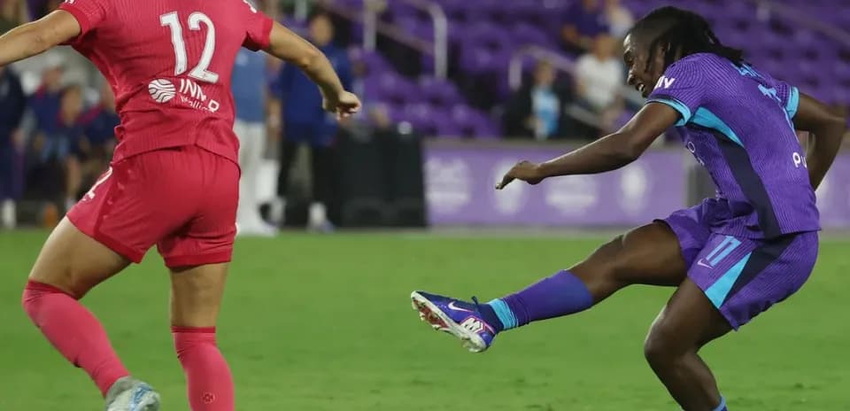 Player kicking the ball during NWSL match