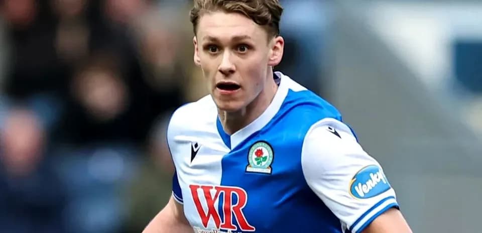 Player in Blackburn Rovers kit running on field