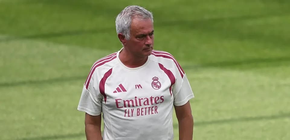 Coach walking on training pitch during session