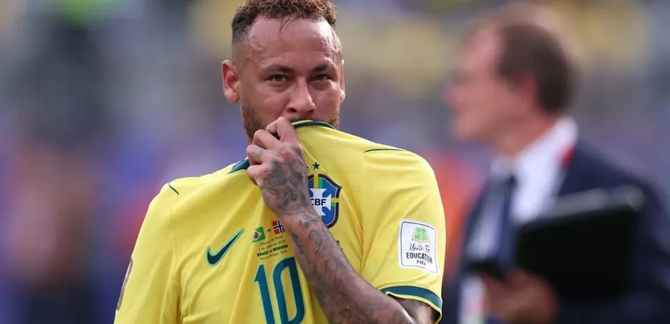 Neymar holding his jersey during a match