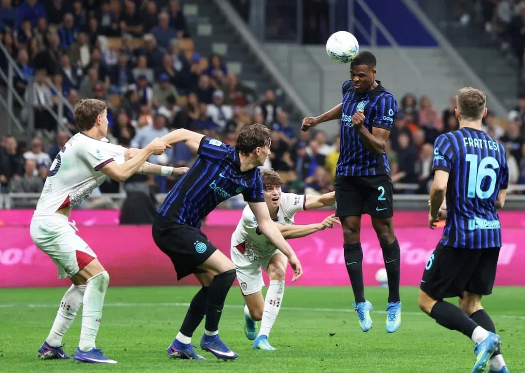 Cagliari player challenged by Inter players in match