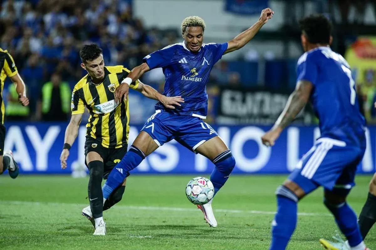 Levski Sofia player dribbling past AEK Athens opponent