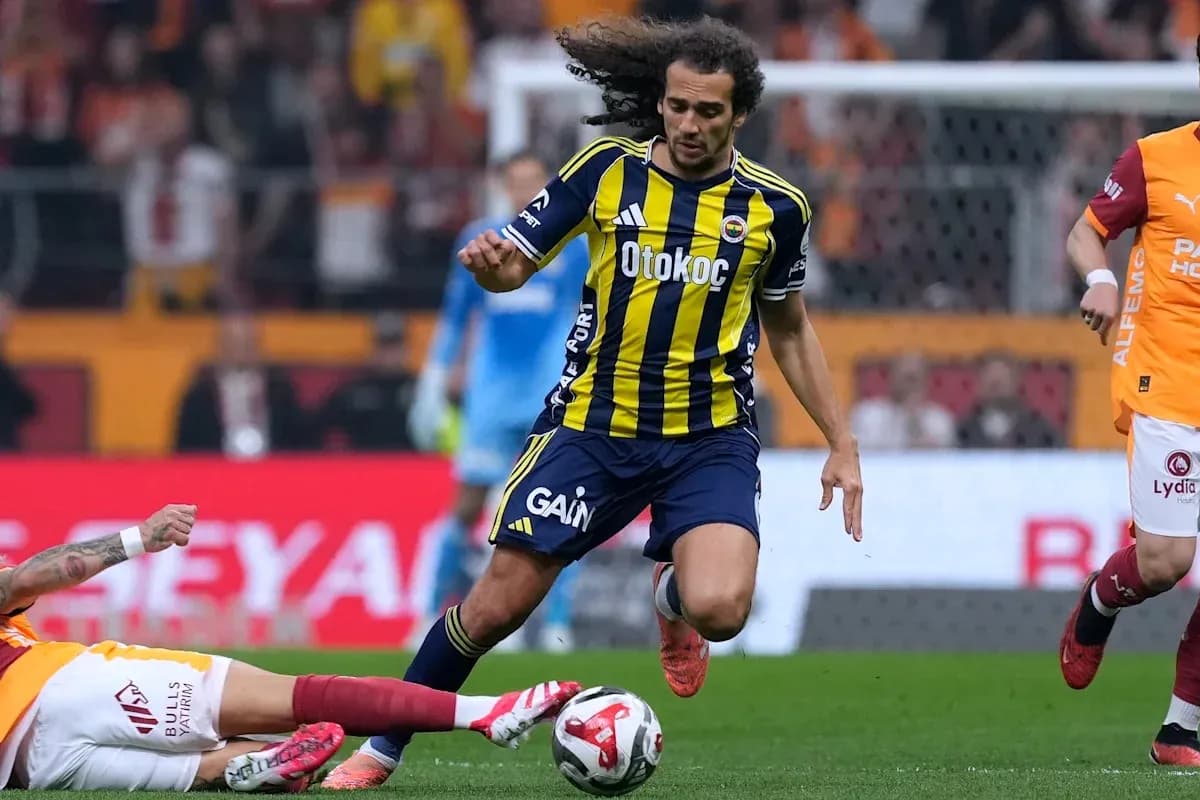 Player from Fenerbahçe dribbling past opponent on field