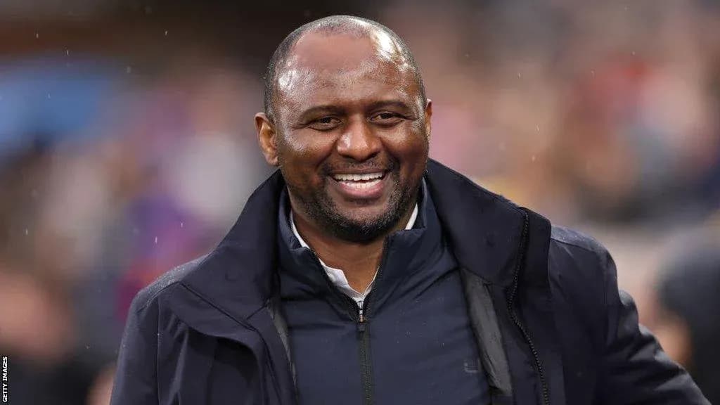 Smiling coach on the sidelines during a match
