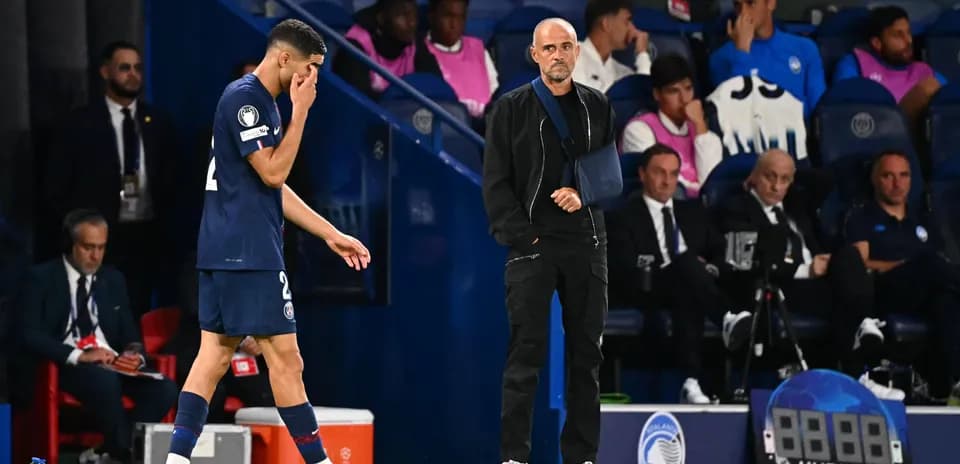 Player leaving field with coach observing during match