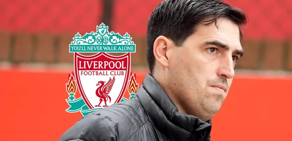 Coach in front of Liverpool FC logo at training ground