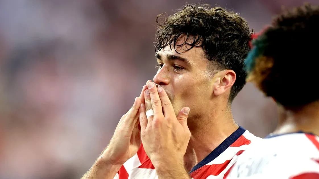 Player celebrating with hands to mouth on field