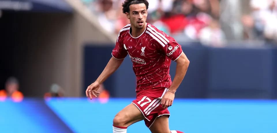 Player running with ball during match for Liverpool