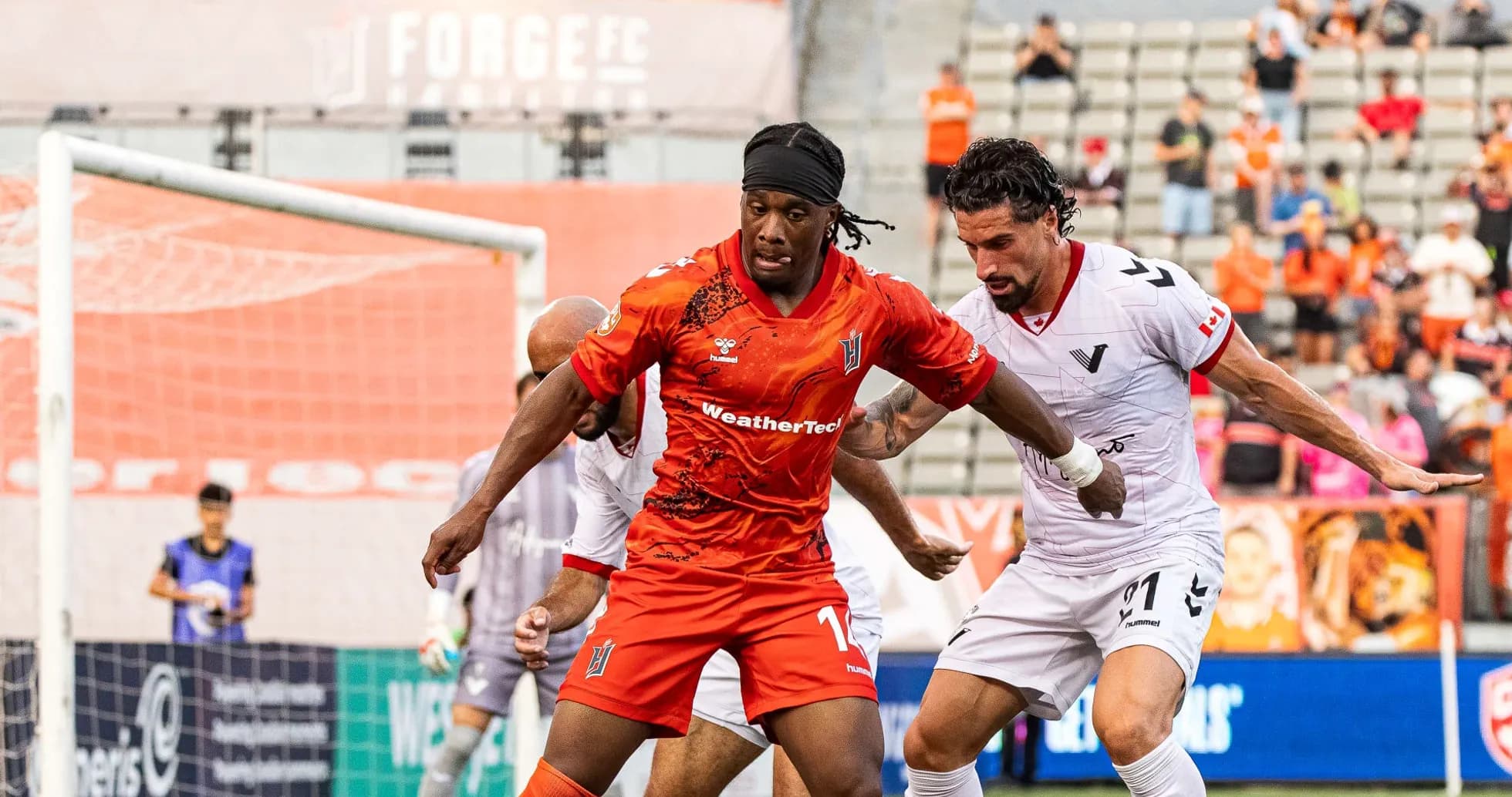Players battling for the ball during Vancouver FC match