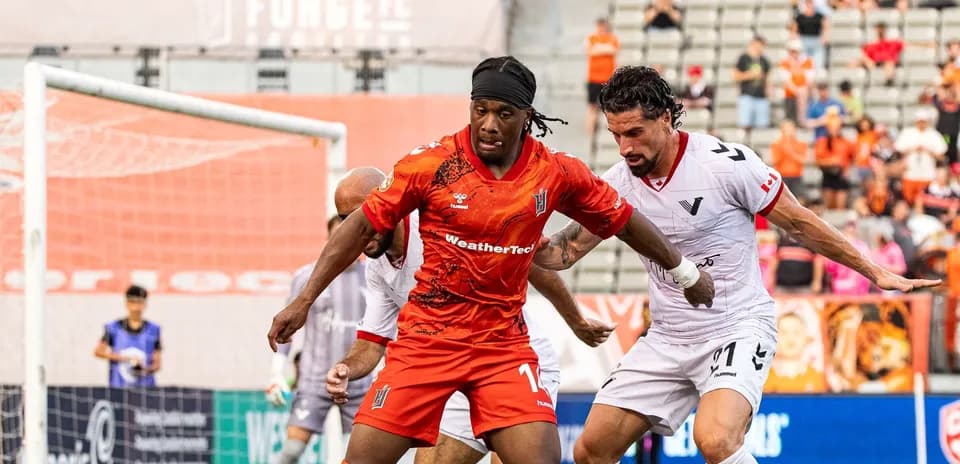Players battling for the ball during Vancouver FC match