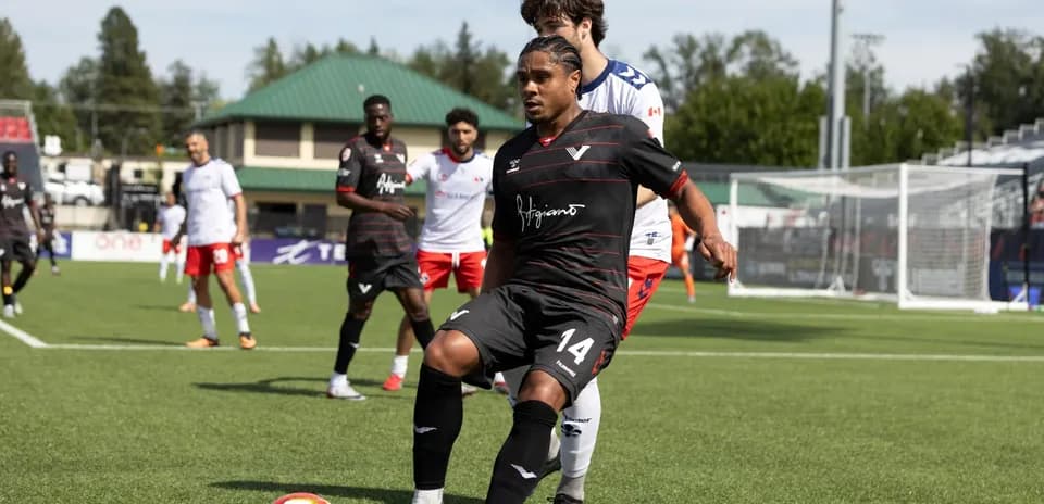 Player in black jersey controlling the ball