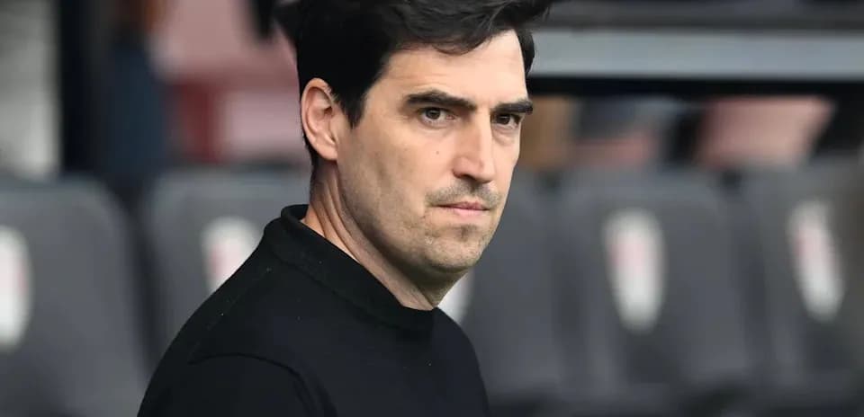 Coach observing from the sidelines during match