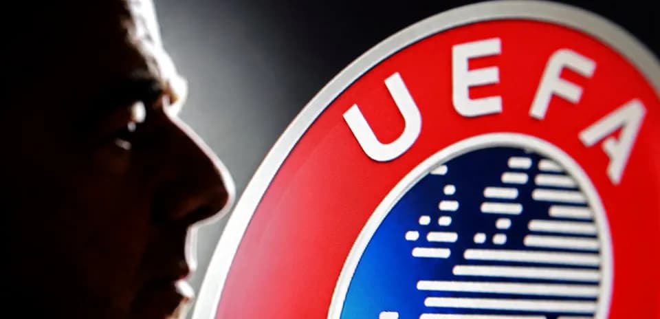Profile silhouette near UEFA logo backdrop