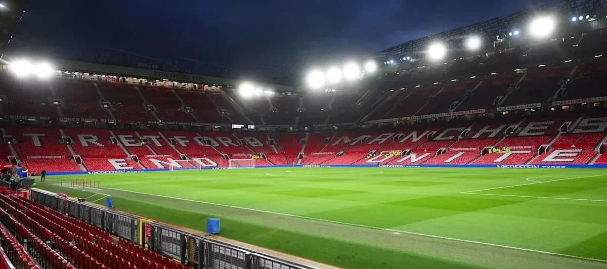 Empty Old Trafford stadium with illuminated stands