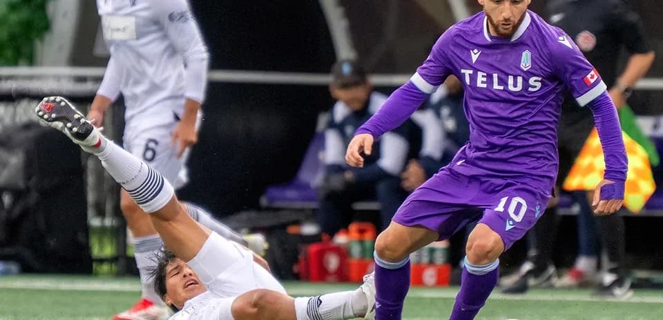 Player in purple jersey avoiding a tackle
