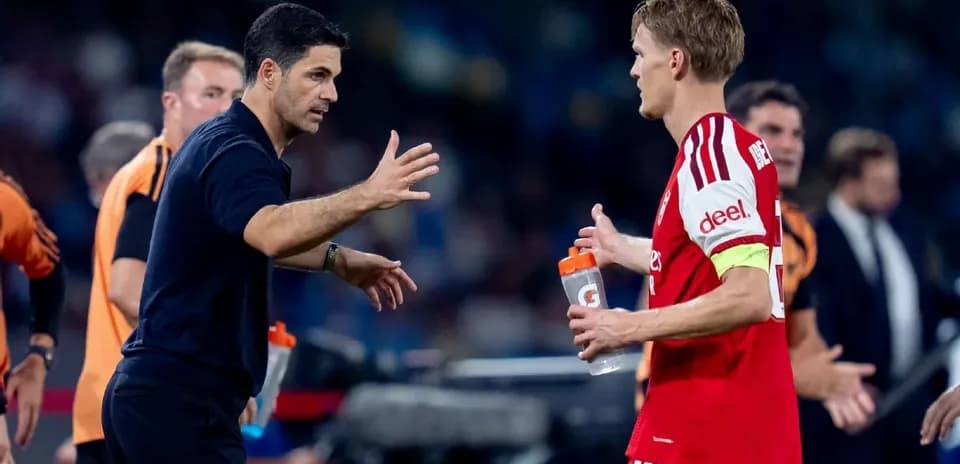 Manager discussing strategy with player during match