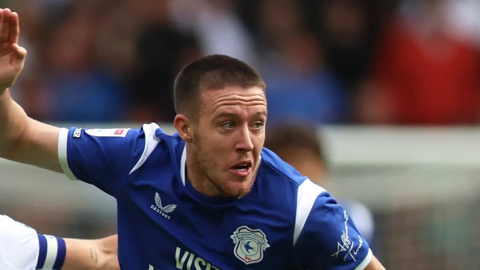 Player in blue jersey running on the field