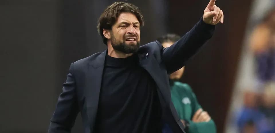 Coach gesturing during a match on the sidelines