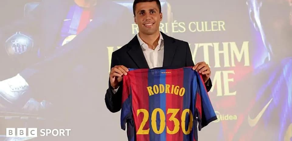 Player holding FC Barcelona jersey at presentation event