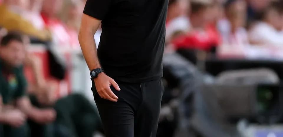 Manager directing players from the sideline during match