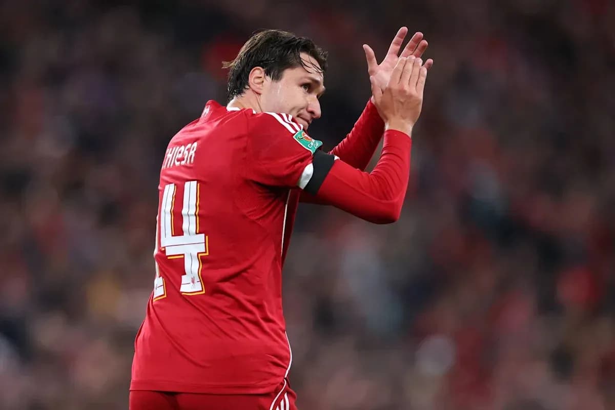 Player applauding fans while wearing red jersey