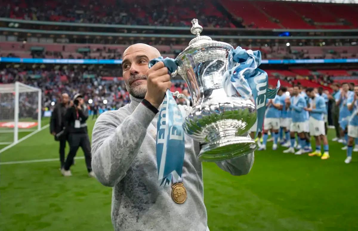 Manager holding FA Cup trophy at Wembley Stadium
