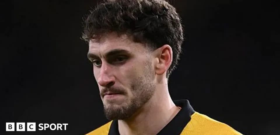 Player in yellow jersey looking down after match