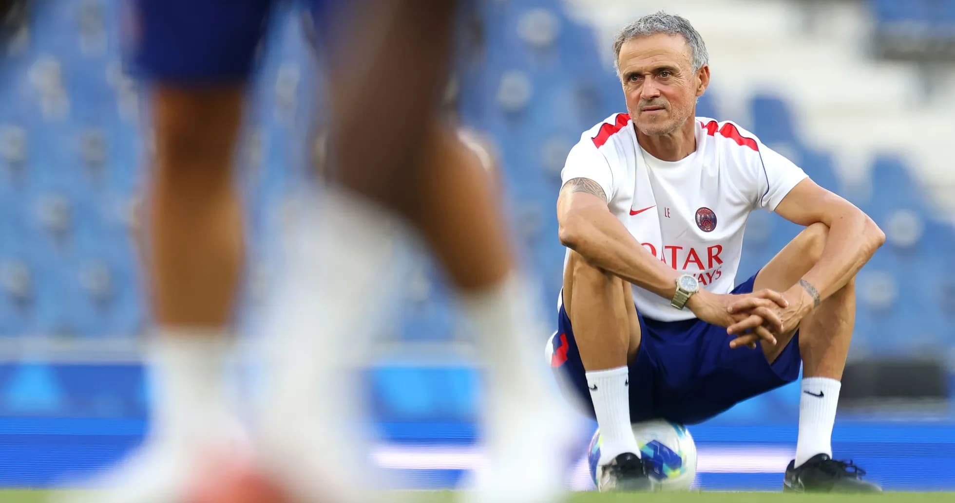 Coach observing players during training session