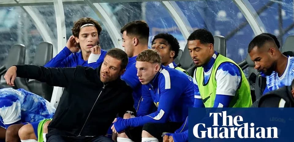 Coach discussing strategy with players on bench