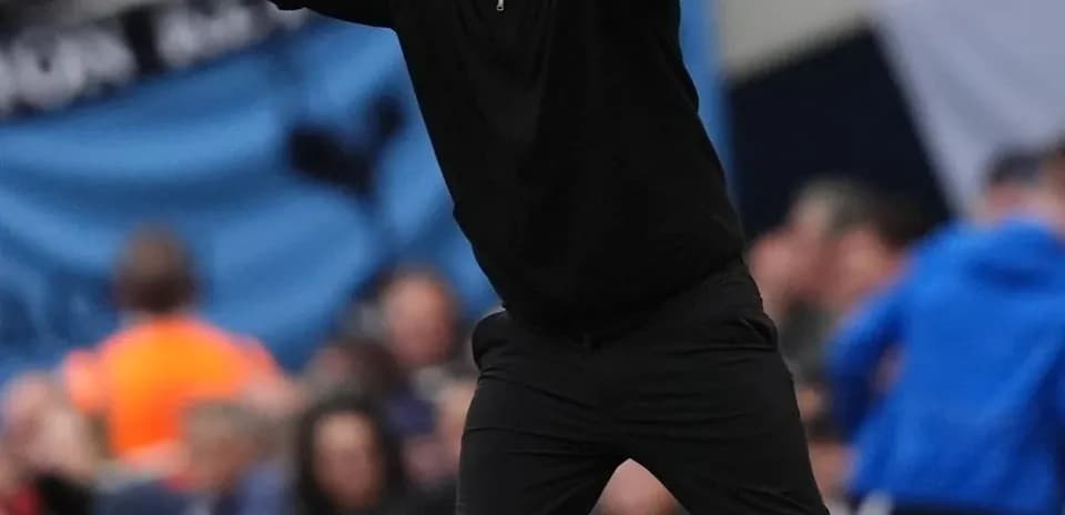 Coach gesturing on the sidelines during match
