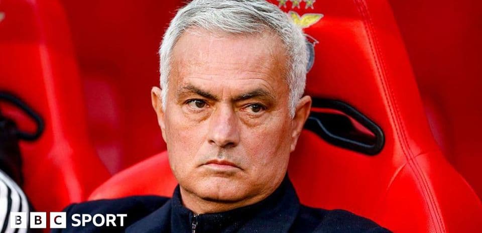 Manager seated on bench during a match