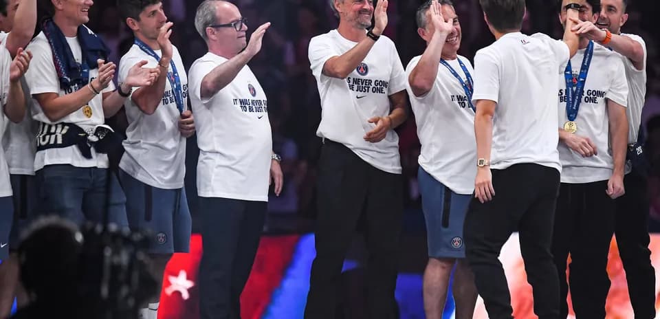 Team celebrating on stage after winning championship