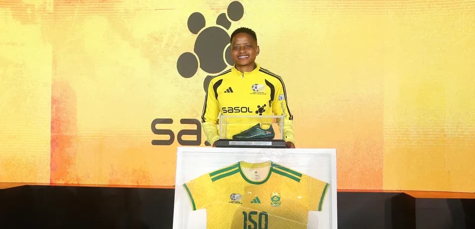 Player presenting jersey and shoe at event