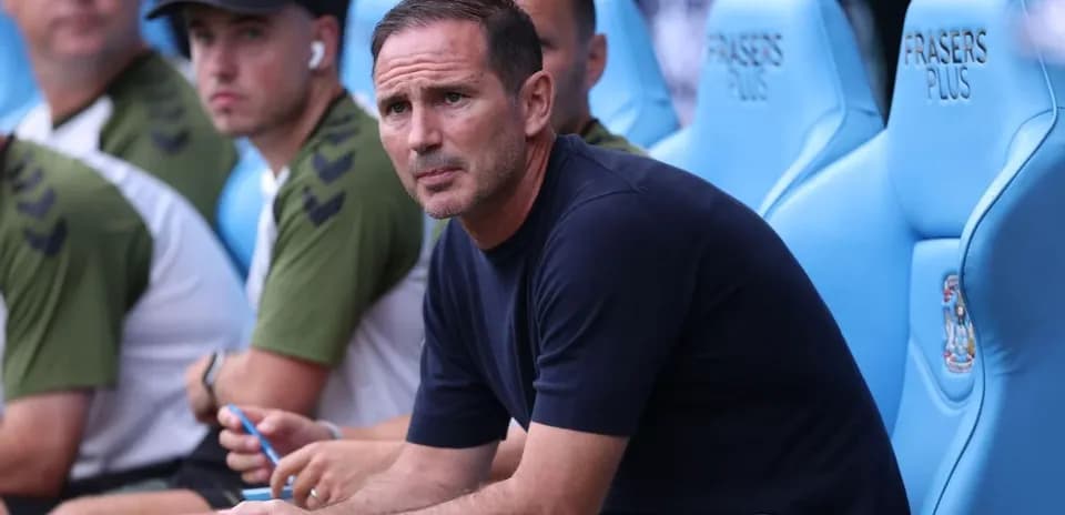 Coach sitting on bench during match