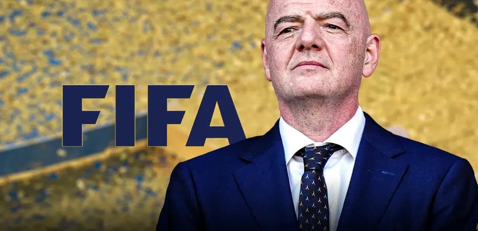 FIFA president standing in front of FIFA logo